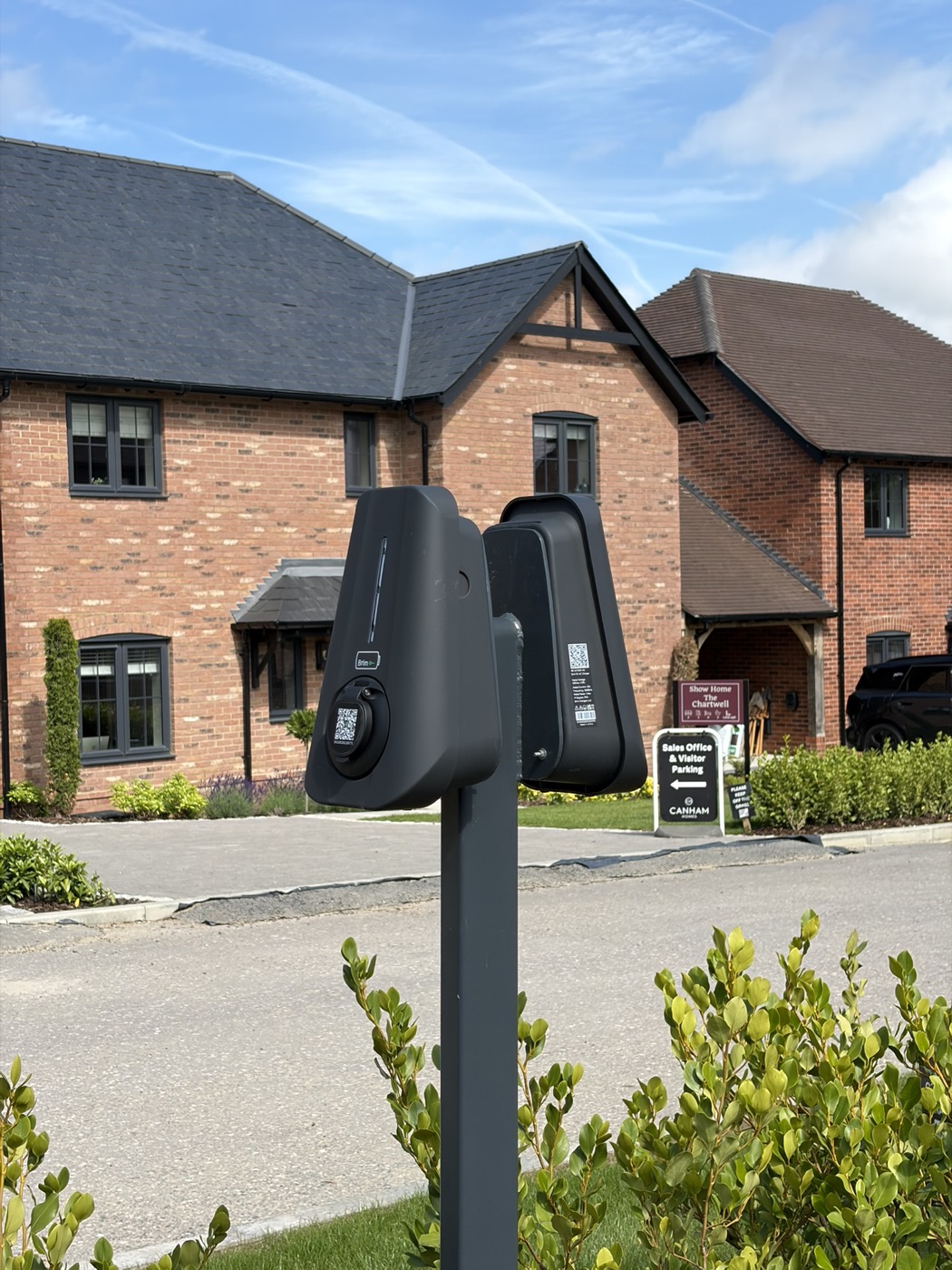 Two Brim chargers on a shared post at a new-build development