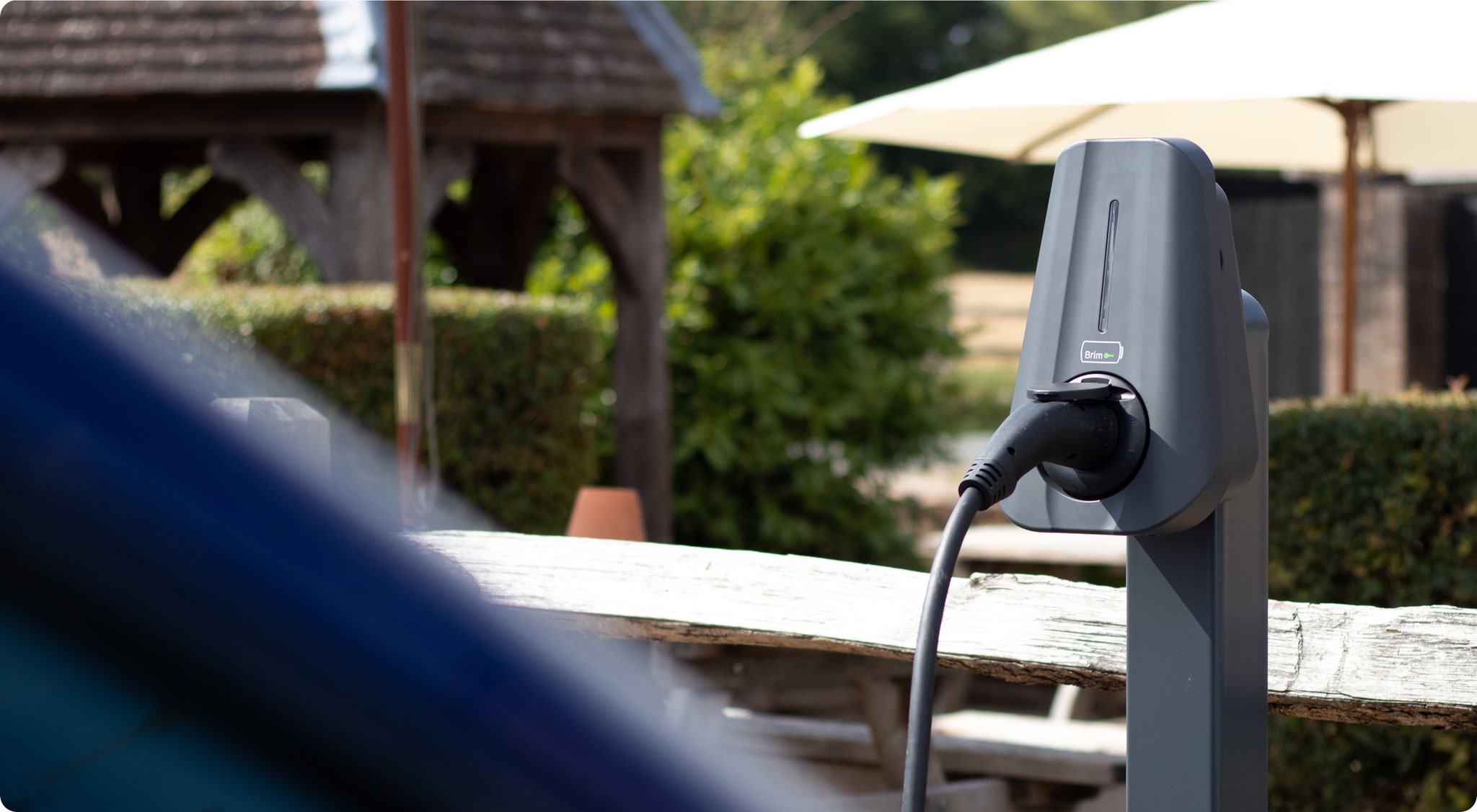 Brim charger on a steel post with a car charging beside it