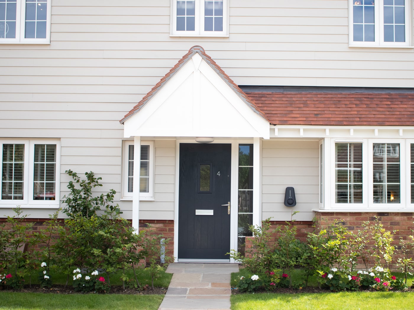 A Brim charger beside the front door of a new-build home